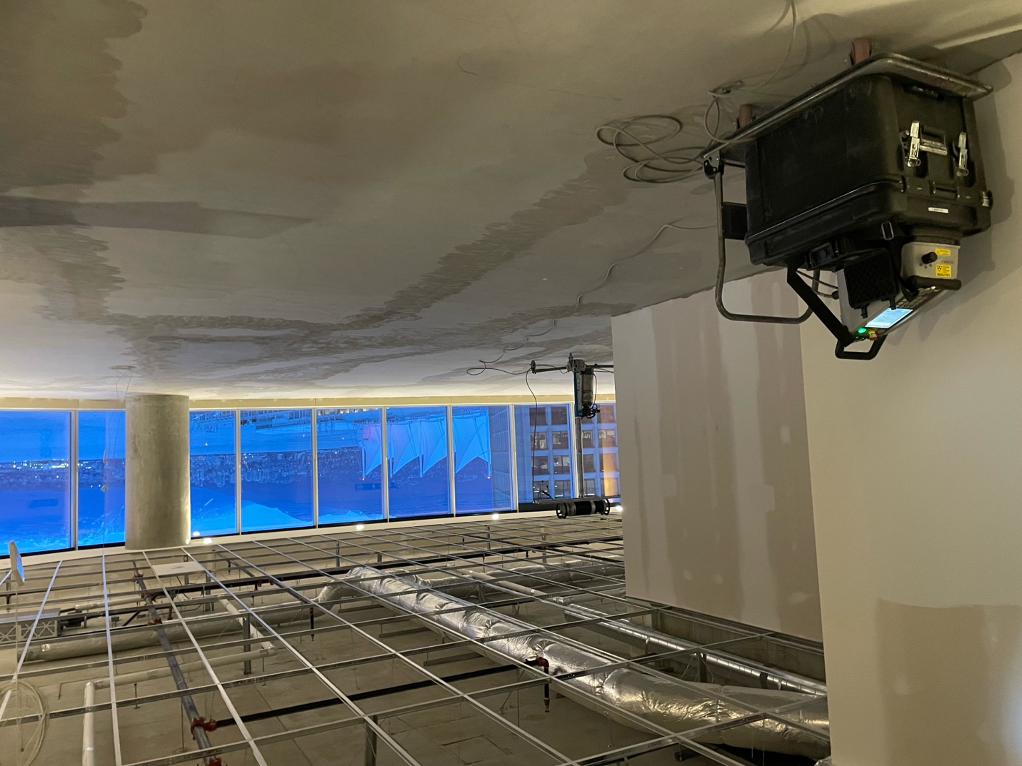 Digital concrete X-Ray panel and source mounted in position on a real jobsite, aimed at a slab during a live shot