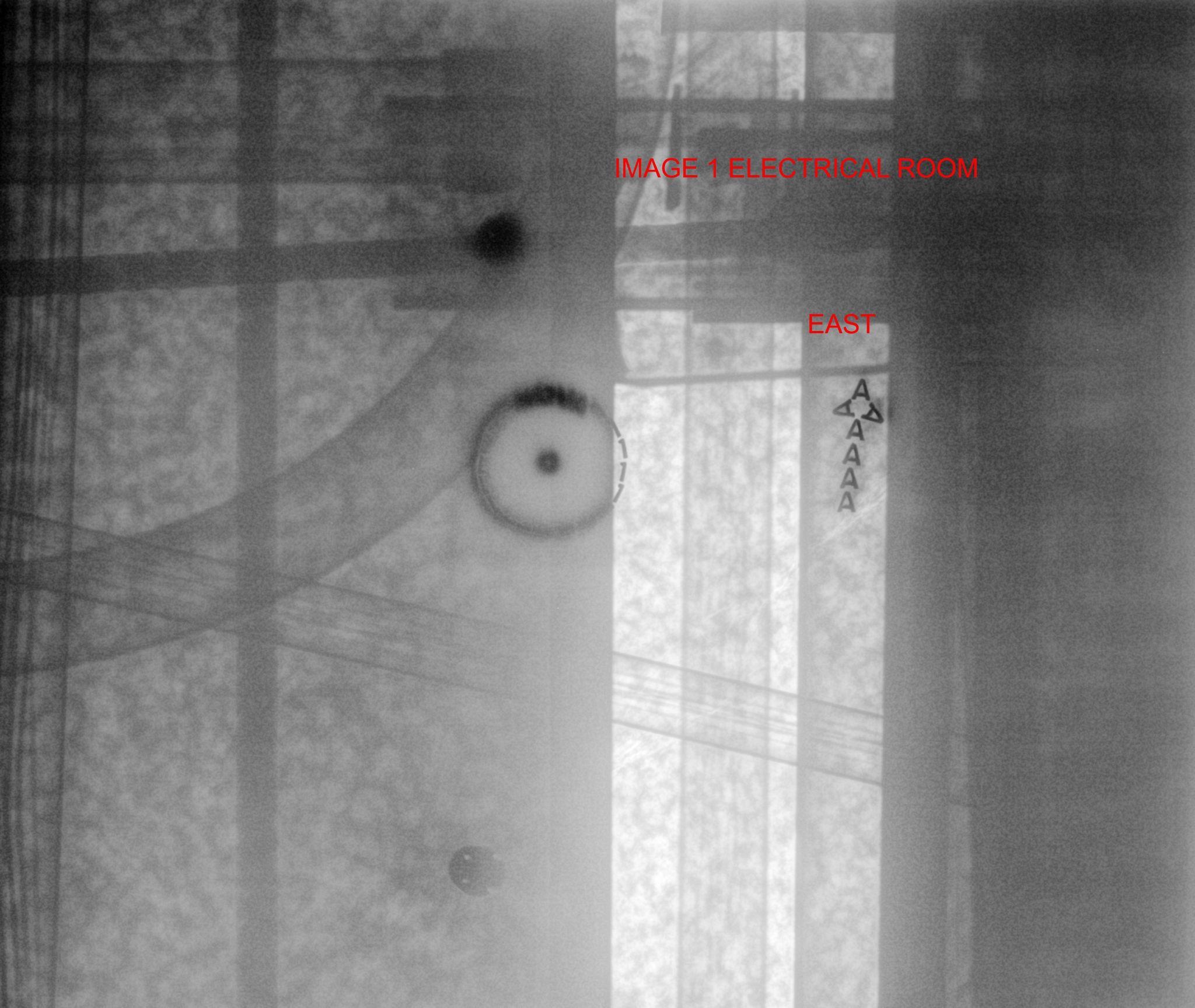 Digital concrete X-Ray radiograph of an electrical room slab on metal deck — rebar, a curved conduit run, and the marked coring circle all clearly resolved through the deck, with an EAST orientation marker